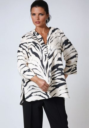 White and black striped blouse with a V-neckline, button detail at the front, three-quarter sleeves, and side slits; lightweight fabric.