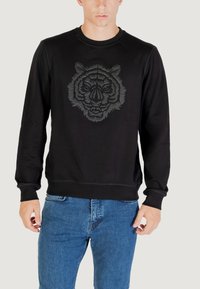 Felpa nera con una grafica a faccia di tigre grigia scura e testurizzata sul davanti. Presenta un collo rotondo e polsini a coste.