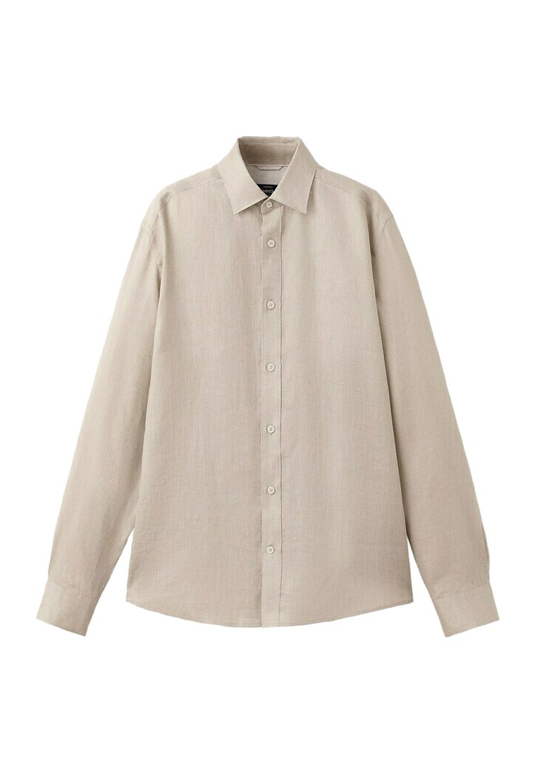 Chemise beige à manches longues avec col pointu, sept boutons sur le devant et poignets boutonnés, présentée à plat sur un fond blanc.