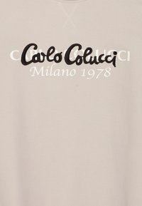 Hellbeige Sweatshirt mit erhabenem schwarzen Schriftzug "Carlo Colucci" und weißem Text "Milano 1978". Weicher, strukturierten Stoff mit lockerer Passform.