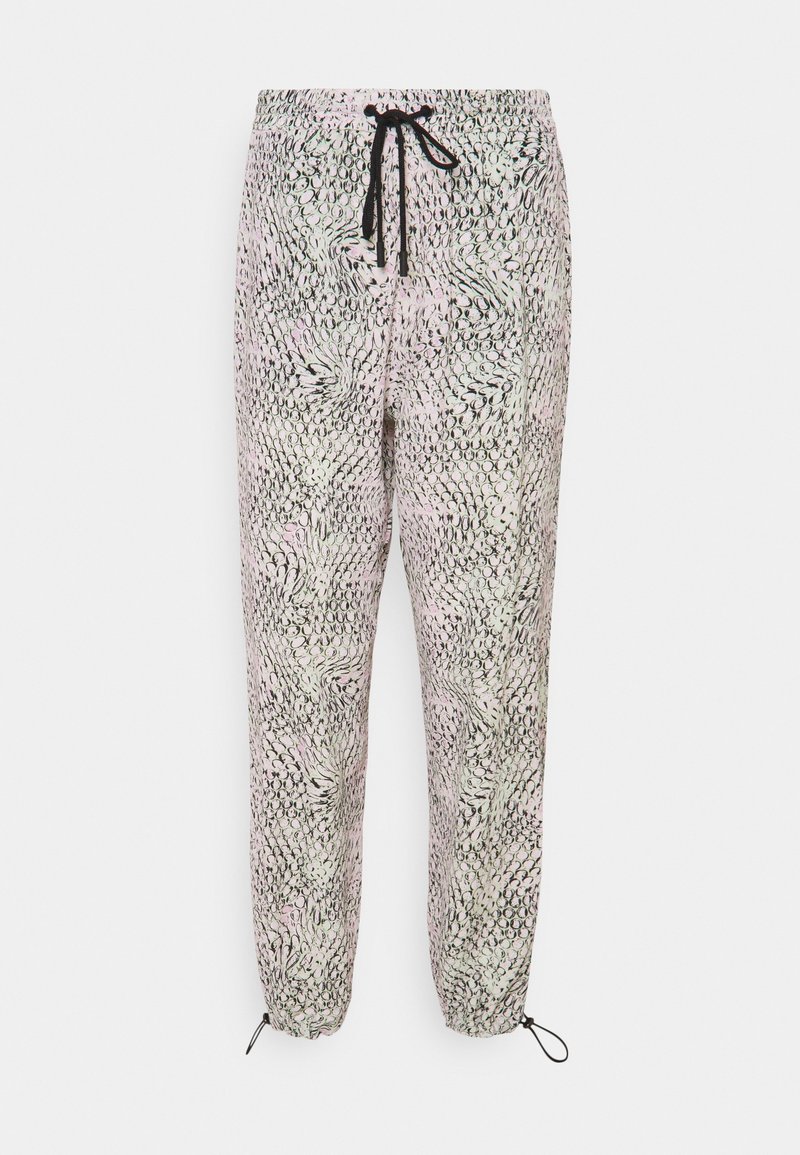 Pantalon ample de couleur claire avec motif abstrait de cercles noirs, taille élastique avec cordon noir et chevilles ajustables avec boucles de corde noire.