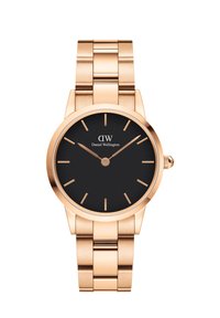 Rose gold watch with a round case, black dial, and minimalist markers. Features a glossy metal bracelet with a polished finish.