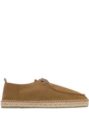 Scarpa espadrillas in camoscio marrone con suola avvolta in juta e lacci beige su sfondo bianco, vista laterale.