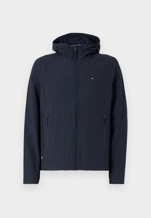 Marineblaues Softshell-Jackett mit Kapuze und seitlichen Reißverschlusstaschen, aus strapazierfähigem Material gefertigt. Verfügt über ein schlichtes Design und kontrastierende Reißverschlussakzente.