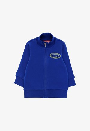 Giacca a zip blu realizzata in materiale morbido. Presenta un colletto alto, polsini a costine e un dettaglio del logo in giallo neon sul davanti.