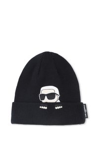 Beanie lavorato a maglia nero con risvolto. Presenta un personaggio ricamato bianco che indossa occhiali da sole e tre punti bianchi sul risvolto.