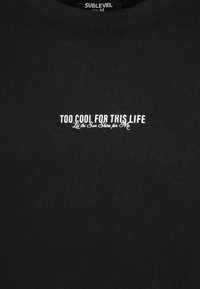 Black cotton t-shirt with a round neck. Features white text: “TOO COOL FOR THIS LIFE” and “Let the Sun Shine for Me” in decorative font.