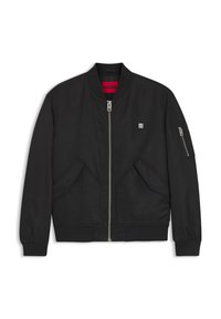 Black bomber jacket with a zip closure, ribbed cuffs, and large side pockets. Features a small logo on the chest and a contrasting red interior.