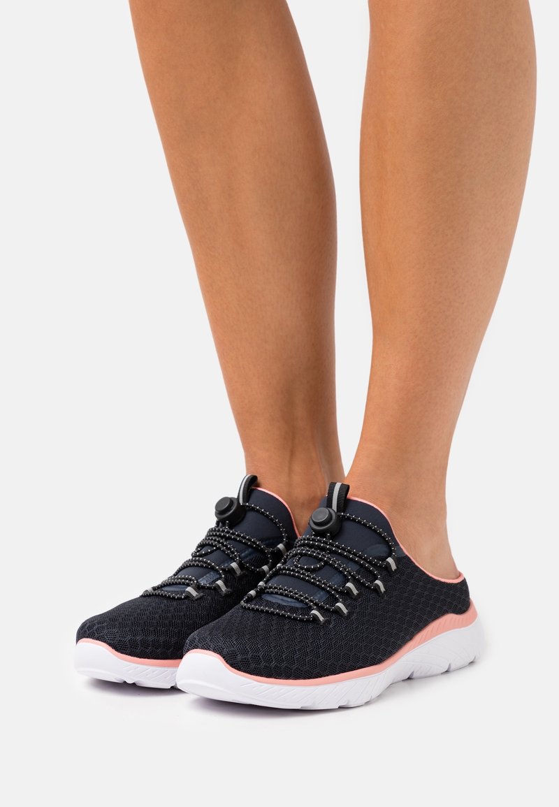 Black mesh sneakers with pink accents, featuring a slip-on design, textured surface, and elastic laces with toggle adjusters.