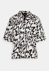 Camicetta a maniche corte con motivo astratto a onde in bianco e nero, design con colletto e chiusura frontale con bottoni. Tessuto morbido e leggero.