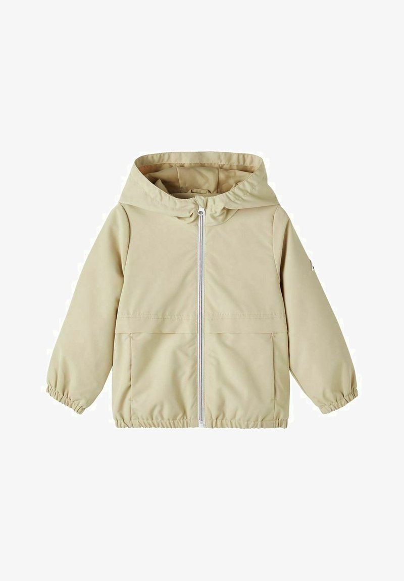 Light beige waterproof jacket with a hood, elastic cuffs, front zip closure, and a large pocket. Smooth texture, minimalist design.