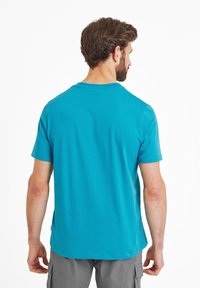 Turquoise short-sleeve t-shirt made of cotton, featuring a crew neck and a smooth texture. Back view shows casual fit and minimal detailing.