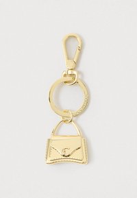 Nøglering i guldfarvet metal med en lille håndtaskecharm og en karabinlås, mærket med "Coccinelle" indgraveret på ringen og karabinlåsen.