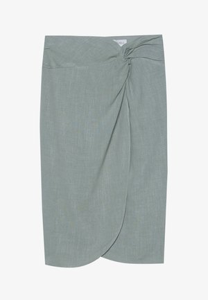 Saia em linho verde-claro com detalhe de nó na cintura, apresentando uma barra assimétrica e um tecido texturizado suave.