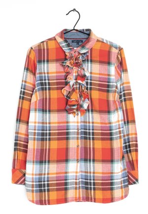 Plaid shirt with long sleeves, featuring ruffled front detail, primarily in orange, red, and yellow with green, blue, and black accents.