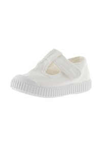 Witte canvas schoen met een klittenbandsluiting, ronde neus en gestructureerde rubberen zool. Eenvoudig ontwerp, lichtgewicht, zonder zichtbare decoratieve accenten.