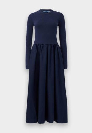 Navy long-sleeve dress with a fitted bodice and flowing skirt, made of soft fabric. Features a round neckline and gathered waist detail.