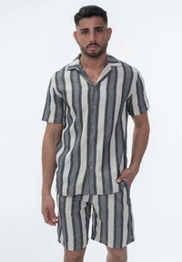 Chemise à manches courtes pour hommes en lin mélangé rayé gris et beige avec boutons. Elle présente un col en V et des poches avant.