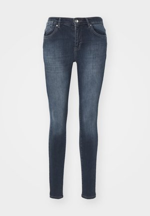 Donkerblauwe skinny jeans van denim met voorkruisen, een ritssluiting en een zilveren knoopsluiting. Kenmerkt subtiele slijtage en vervaging.