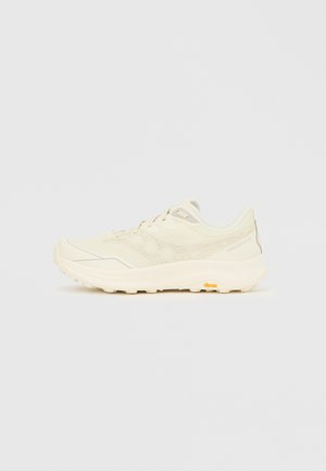 Lys beige løpesko med en teksturert overdel, reflekterende detaljer og Vibram-såle. Lett design med polstret mellomsåle for komfort.