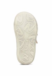 Light-colored rubber shoe sole with a textured pattern featuring circular logos and a central inscription. Designed for grip and durability.