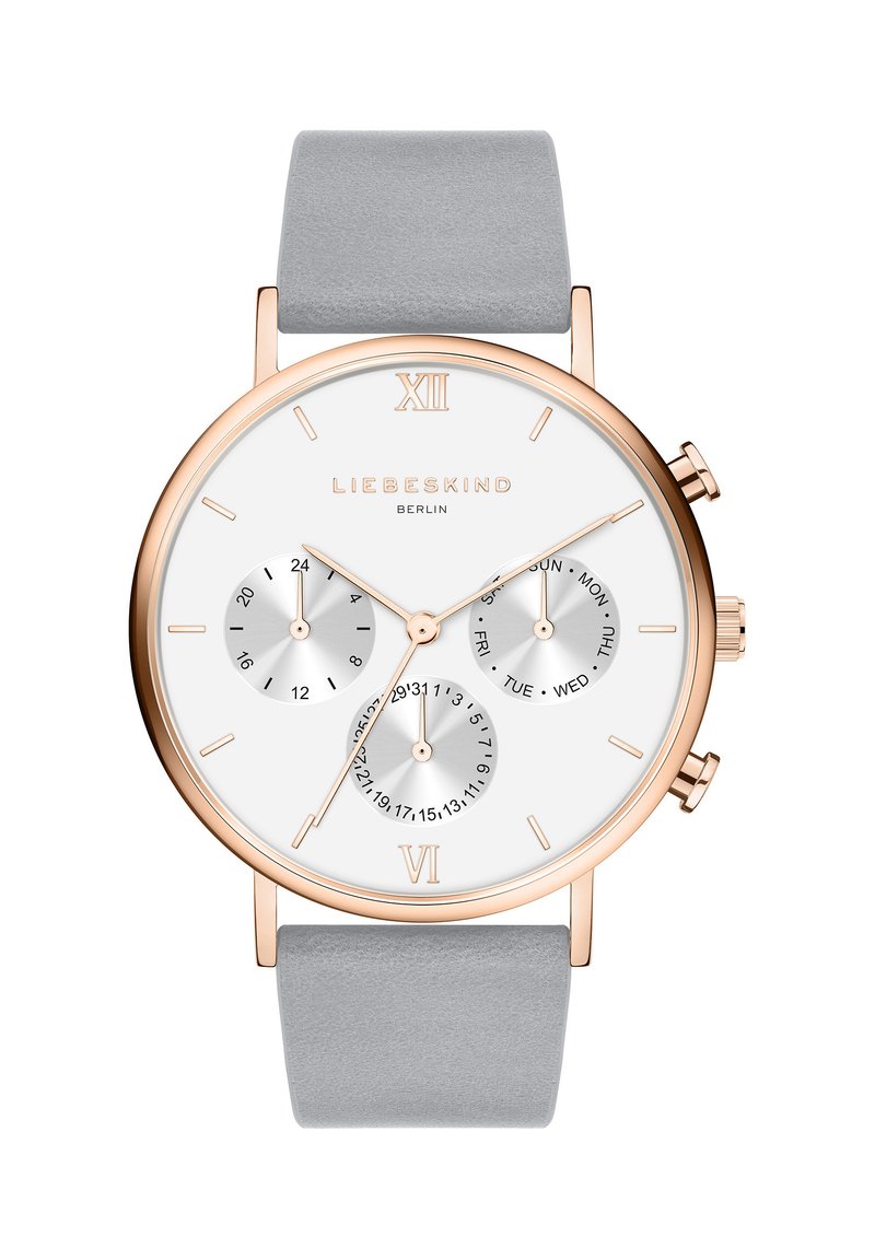 Runder silberner Uhr mit einem roségoldenen Gehäuse, grauem Lederarmband und drei kleineren Zifferblättern für Tag und Datum. Römische Ziffern bei 12 und 6.