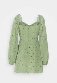 Vihreä mekko, jossa on puffihihat, neliön muotoinen pääntie ja mustat pilkut. Tasaista kangasta, joka on muotoiltu istuvaksi ja selässä vetoketjukiinnitys.