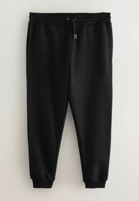 Melnas, pieguļoša stila sporta bikses ar elastīgu jostu, regulējamu šņori un sānu kabatām. Izgatavotas no mīksta, gluda auduma.