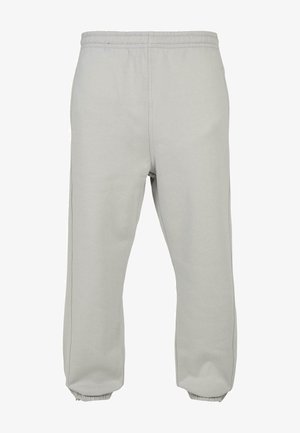 Light gray sweatpants made of soft fabric, featuring an elastic waistband, tapered legs, and ribbed cuffs for a comfortable fit.