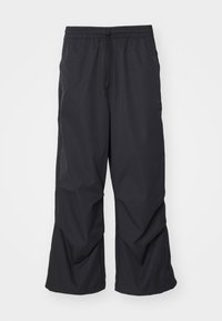 Schwarze, weit geschnittene Hosen aus leichtem Stoff. Mit einem elastischen Taillenbund und einem Kordelzug sowie dezenten Seitentaschen.