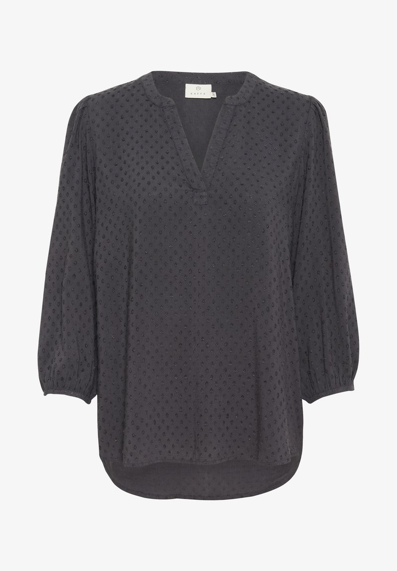 Blouse noire avec décolleté en V, manches ballon et pois texturés partout. Tissu doux avec une coupe légèrement ample et un ourlet incurvé.