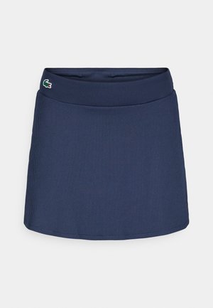 Dunkelblaue, gerippte Golfröcke mit breitem Taillenbund und gesticktem Logo-Akzent auf der linken Seite. Hat einen geraden Schnitt und weiche Textur.