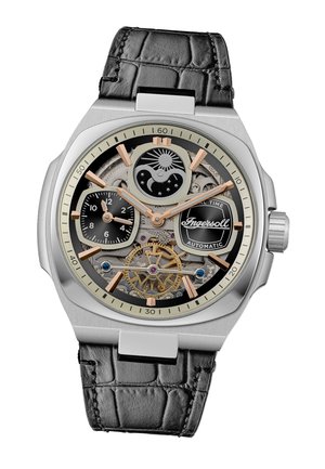 Montre automatique avec un bracelet en cuir de crocodile noir, boîtier en acier inoxydable, cadran transparent, rouages dorés et accents argentés affichant un motif céleste.