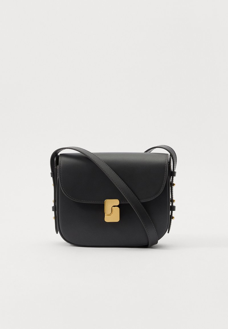 Black leather crossbody bag with a flap top, gold hardware, and decorative studs along the side. Features an adjustable strap for versatility.