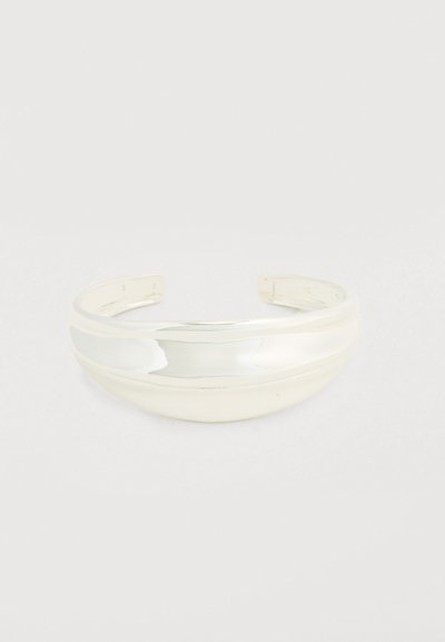 Bracelet manchette en métal argenté poli. Caractérisé par un design lisse et arrondi avec un large bracelet incurvé, ouvert aux deux extrémités pour un ajustement réglable.