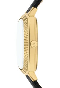 Montre octogonale dorée avec un bord texturé, un cadran blanc et un bracelet en cuir noir. Elle est dotée d'une couronne ronde sur le côté.