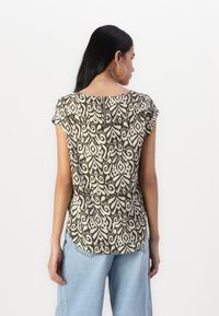 Krátky rukáv, olivový zelený top s bielym paisley vzorom, zakrivený lem a zips na chrbte, vyrobený z ľahkého materiálu.