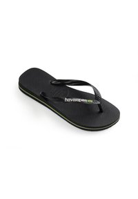 Černé gumové žabky s texturovanou stélkou, tenkými řemínky a zeleným akcentem podél podrážky. Obsahují logo "havaianas".