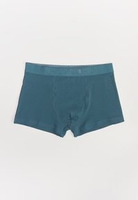 Bokserki w kolorze turkusowym, wykonane z miękkiej tkaniny, z elastycznym paskiem w nieco ciemniejszym odcieniu. Charakteryzują się regularnym krojem i średnim stanem.