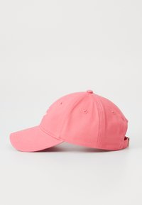 Pink cotton baseball cap with a rounded crown and a curved brim. Features stitching details and a metal clasp for adjustability.