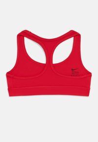 Rdeča športna modrček Nike Dri-FIT z racerback obliko in črnimi Nike swoosh logotipom na hrbtu, velikost ekstra majhna.