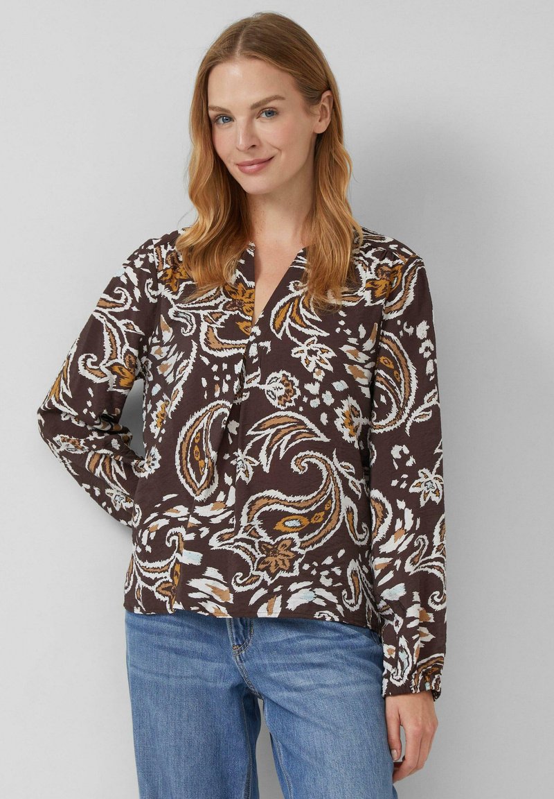 Lange mouwen blouse in bruin met een bloemig paisleypatroon in beige, mosterd en wit. Heeft een v-hals en een relaxte pasvorm.