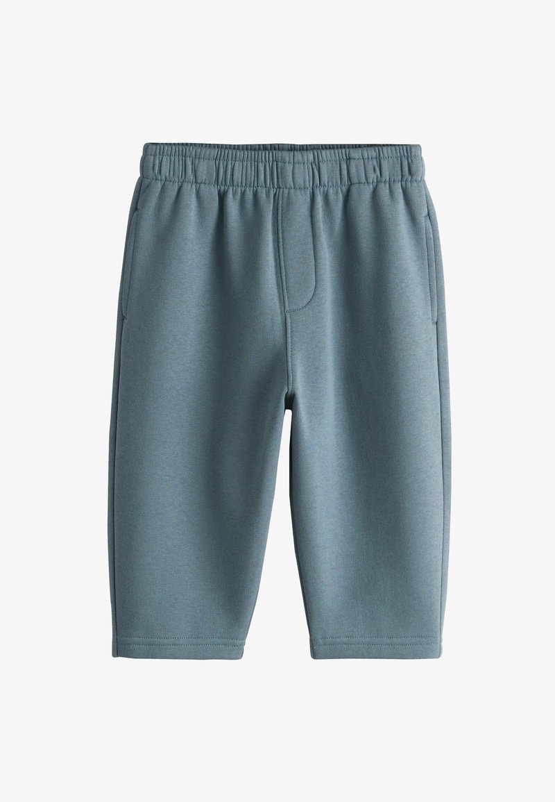 Pantalones cortos de punto grises con cintura elástica, con bolsillos laterales y diseño ajustado. Textura suave y corte hasta la rodilla.