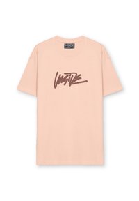 Camiseta de algodón de color rosa claro con un prominente texto gráfico en marrón con la palabra "INSIDE" en el frente. Cuello redondo y mangas cortas.