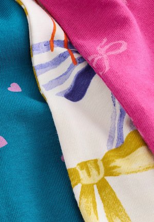 Three pieces of fabric: turquoise with pink hearts, white with a colorful bow pattern, and solid pink. Textured ribbed and smooth surfaces.