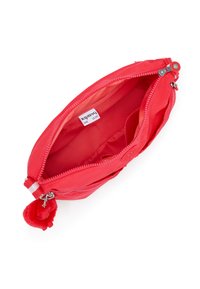 Röd nylonpåse med dragkedja, med en plysch pom-pom-dekor och en etikett inuti. Insidan är slät och utan märkningar.
