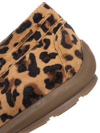 Leopard print suede shoe upper with visible stitching and a brown rubber sole in close-up detail.