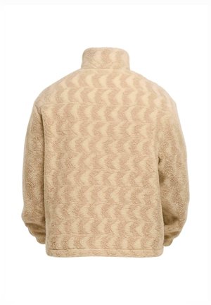 Beige színű polárdzseki hullám mintázattal, magas gallérral és laza fazonnal. Texturált felület, puha anyag, alkalmas mindennapi viseletre.