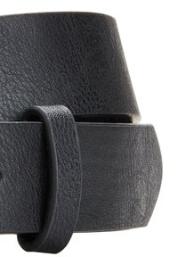 Une ceinture en cuir noir présente une texture lisse avec un motif légèrement embossé. Le design comprend une boucle classique et une extrémité effilée.