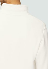 Witte sweatshirt met een hoge kraag, textuurstof en zichtbare stiksels langs de schoudernaad. Achteraanzicht weergegeven.